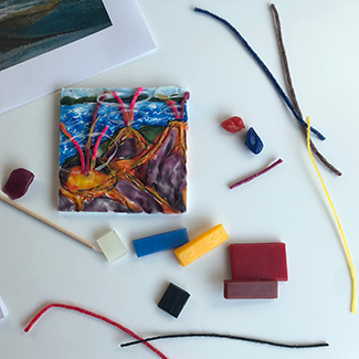 Wax On Red, white, yellow and blue wax beside a small wax canvas of three volcanos