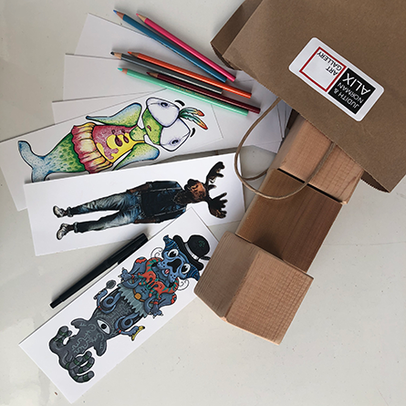 Drawing Twists Brown paper bag with colourful drawings, wood blocks and pencil crayons falling out