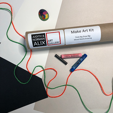 Think Big, Draw Big Large tube next to orange and green string, and colourful crayons